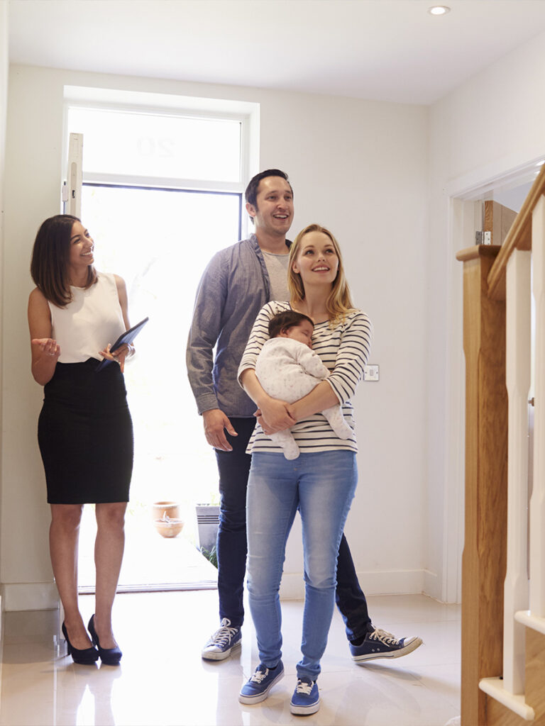 couple with baby touring a house