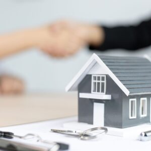 home with keys and people shaking hands