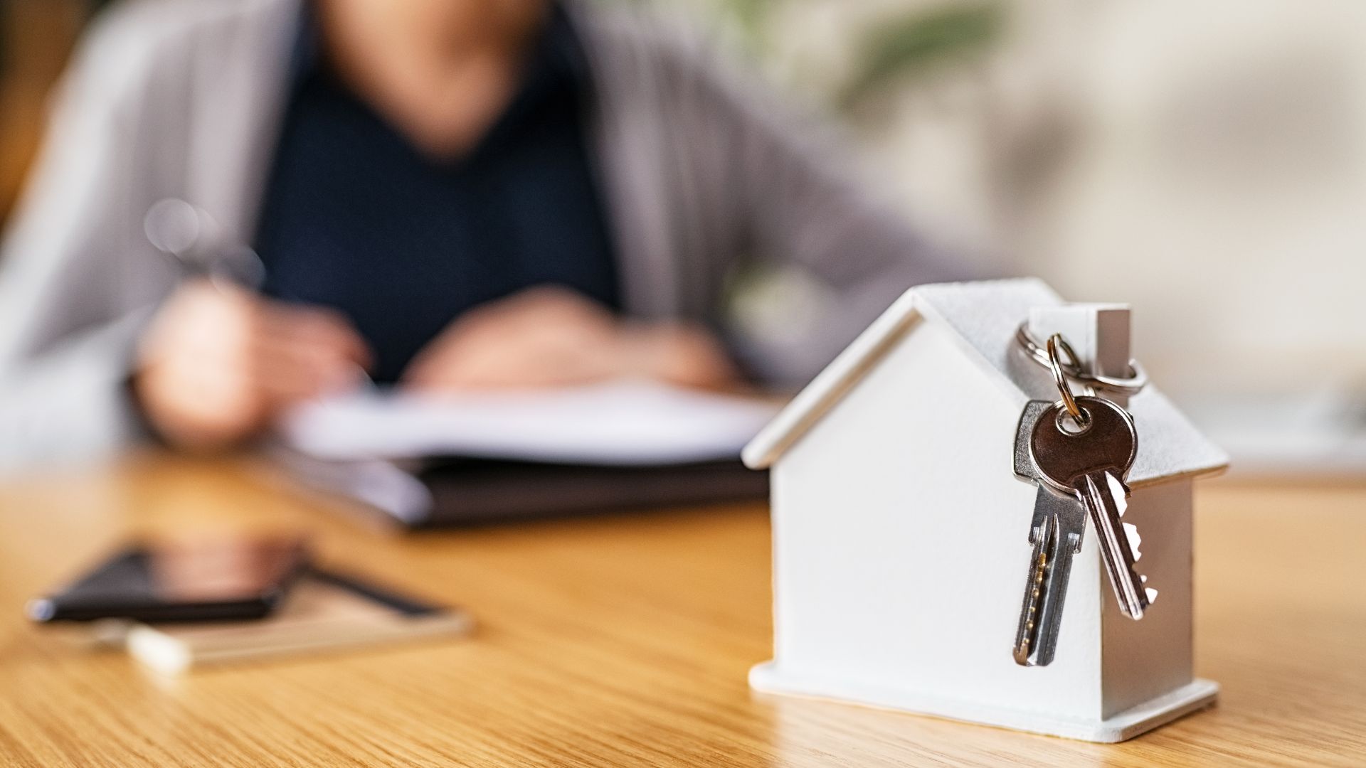 figure of a house with keys on table