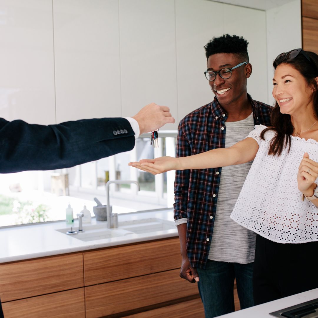 Couple accepting keys to new home
