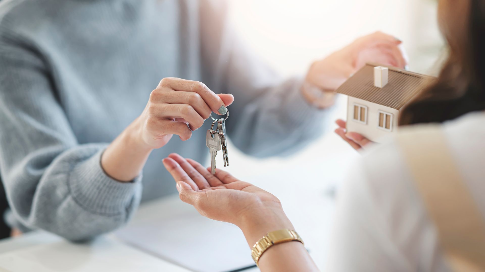 Real estate agent handing buyer keys