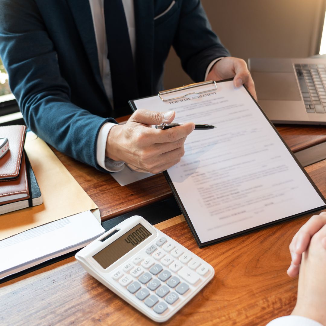 Broker showing purchase agreement to client