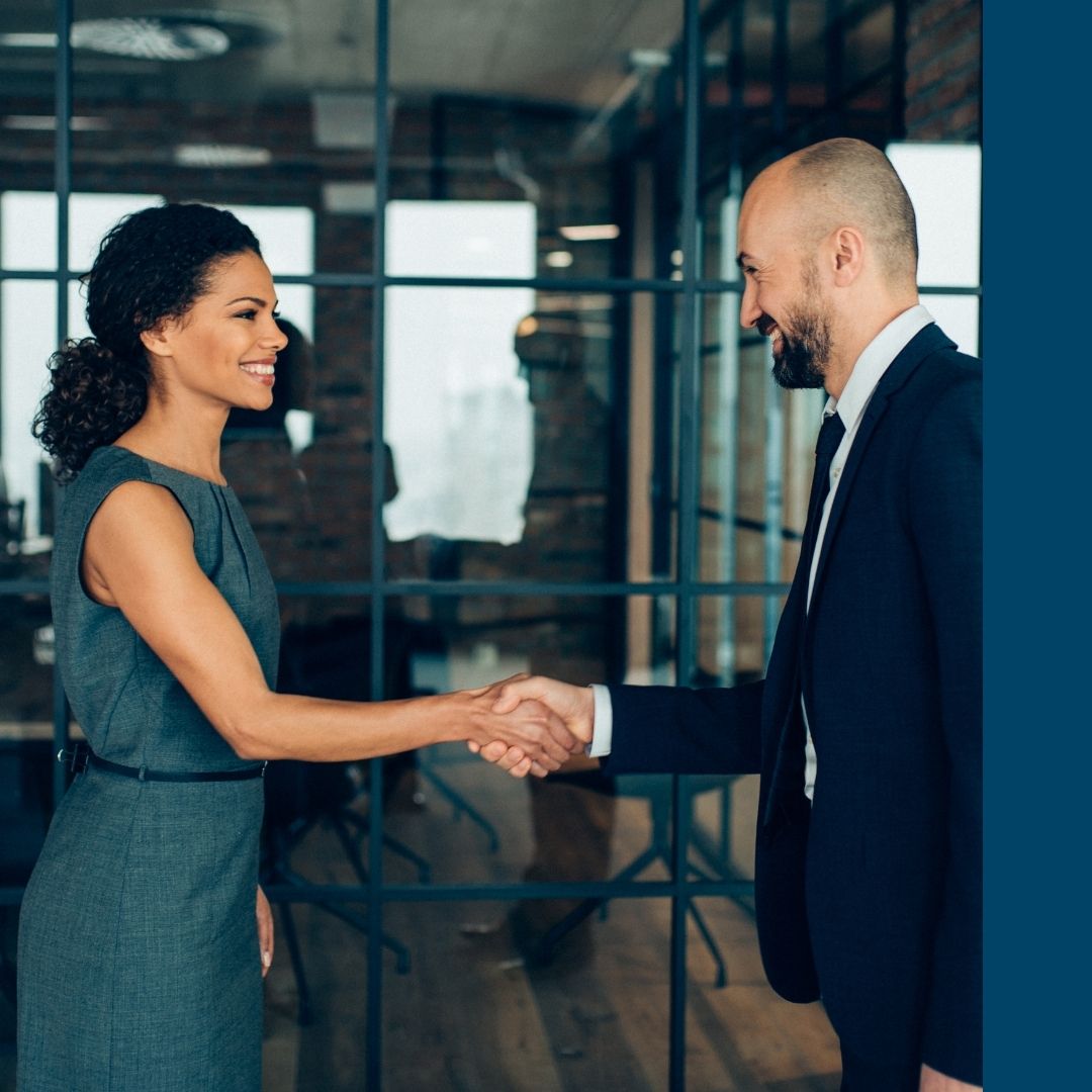 real estate agent shaking hands with a client