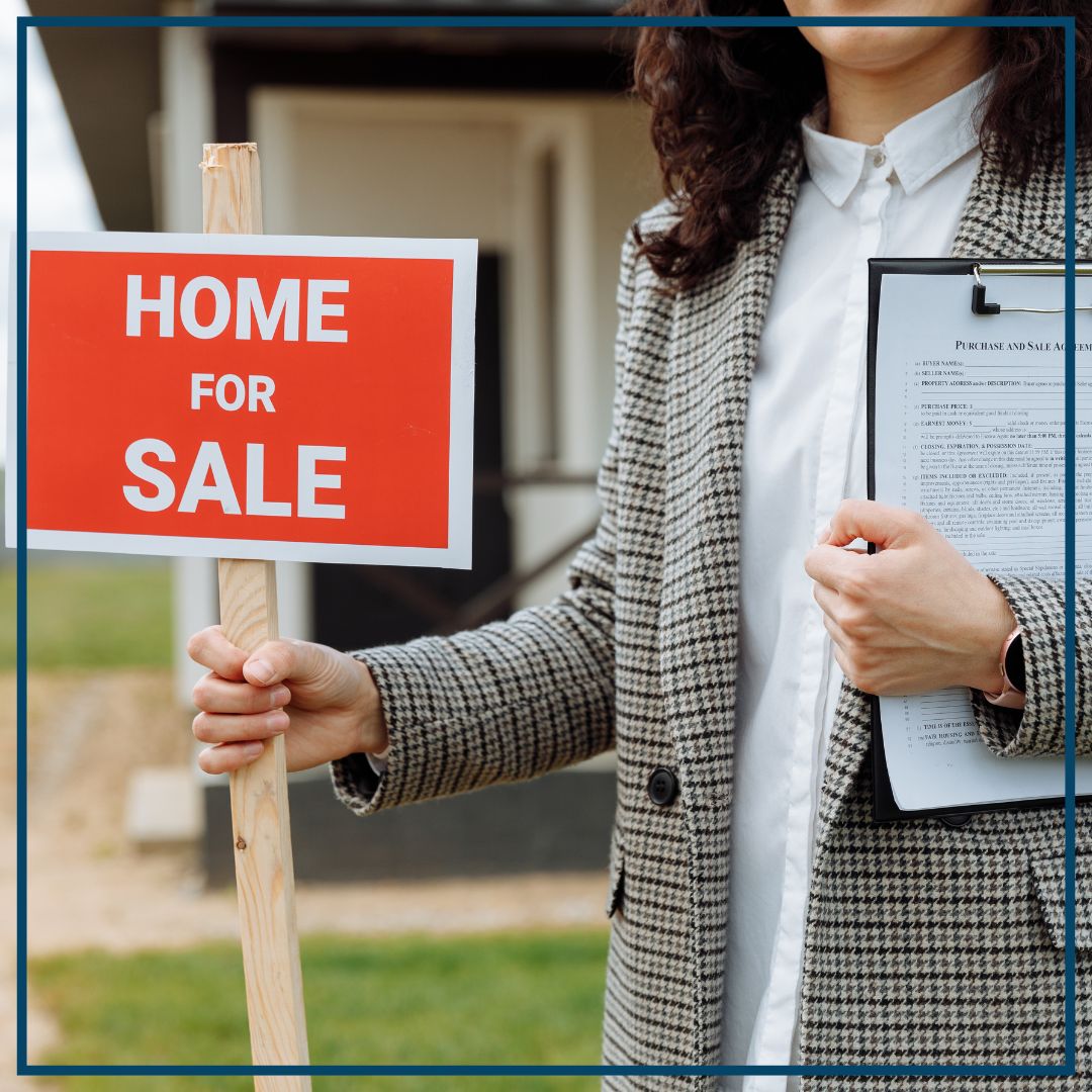 realtor with home for sale sign