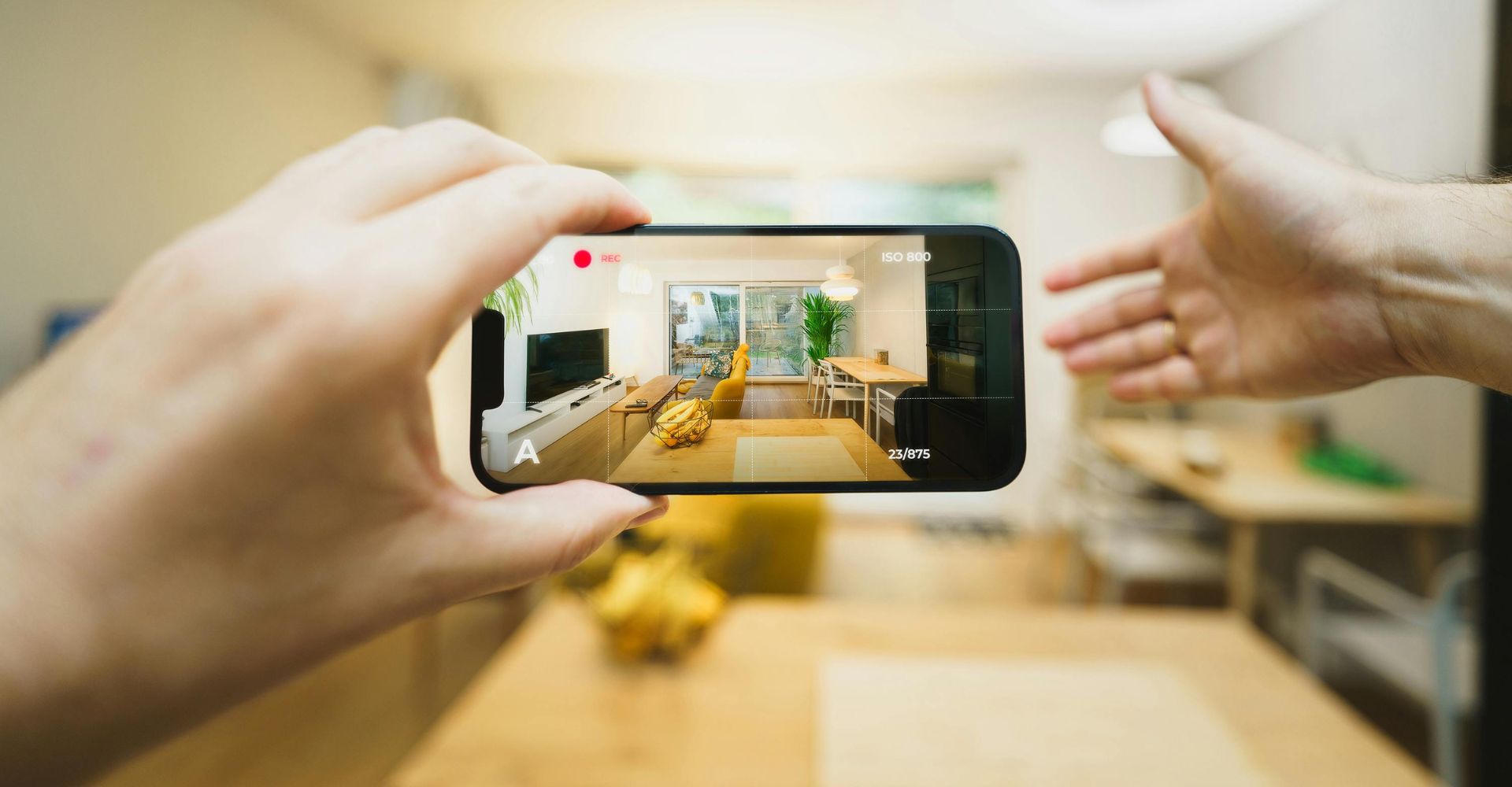 person capturing inside of home with phone