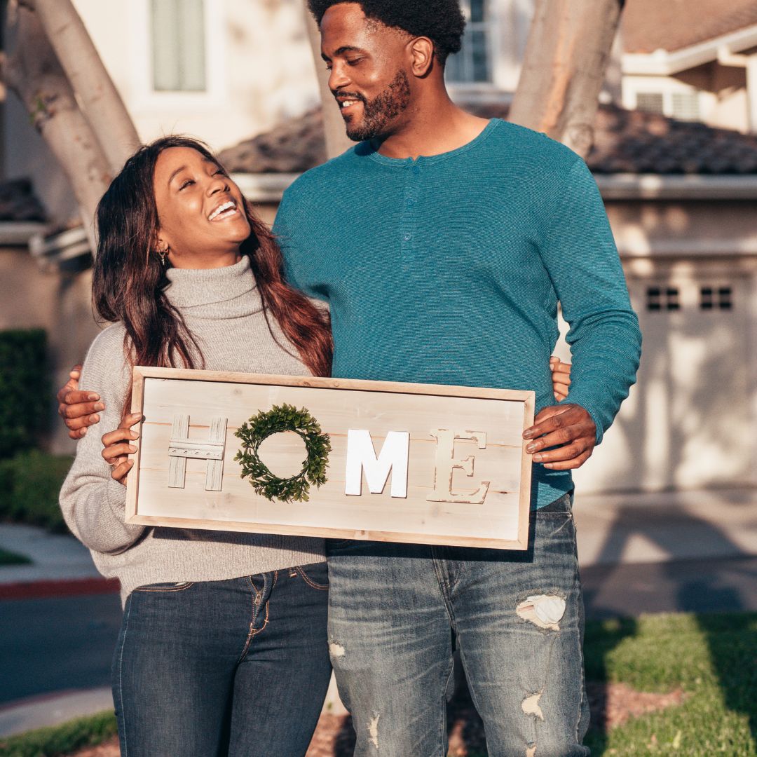 couple in front of new home