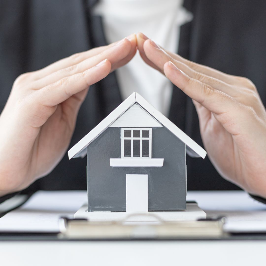 hands covering home
