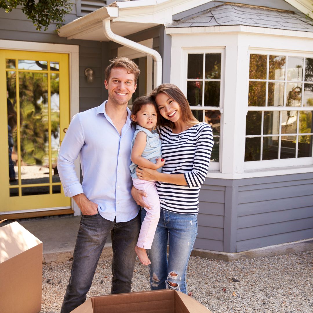 family in front of home
