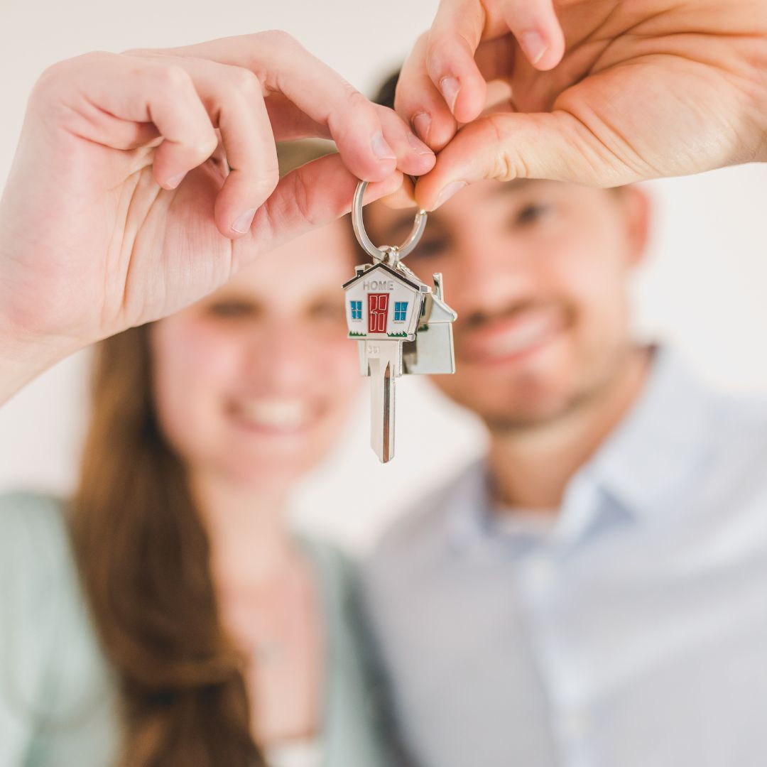couple holding new home keys